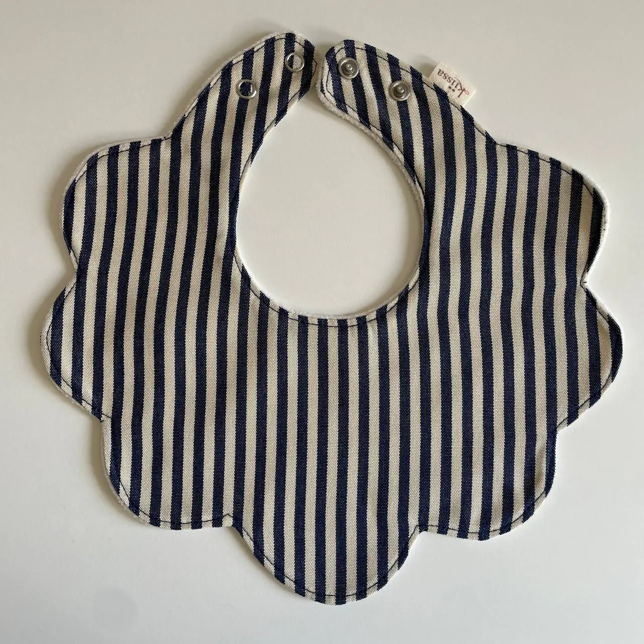 A striped bib in navy and cream